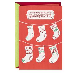 a christmas card with stockings hanging on a clothes line and the words, christmas wishes for granddaughter