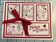 a handmade christmas card with red ribbon and holly decorations on it, featuring the words peace on earth