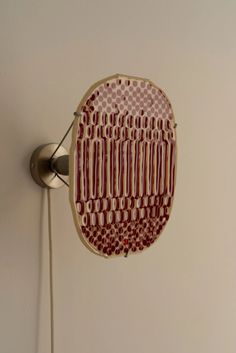 a red and white object hanging on the wall