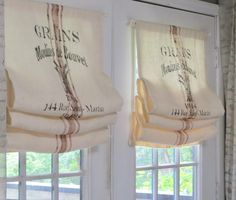 two windows with roman blinds in front of them and the words grisss on them