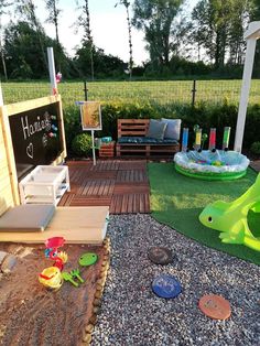 an outdoor play area with sand and toys