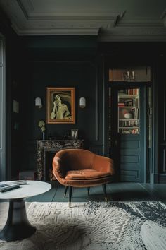 a living room with black walls and an orange chair