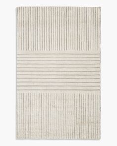 a white rug with vertical stripes on the top and bottom, against a white background