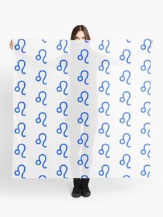 a woman is holding up a large poster with blue question markes on it's sides