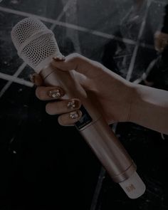 a person holding a microphone in their hand