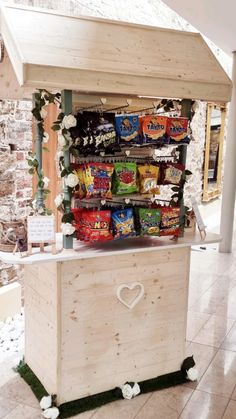 a wooden stand with food on it in front of a brick wall and flooring