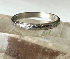 a silver ring sitting on top of a rock