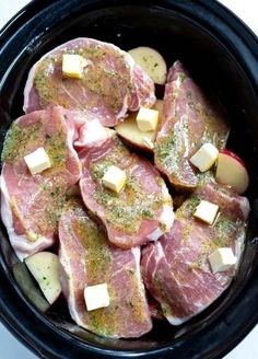 raw meat in a slow cooker ready to be cooked with butter and seasoning