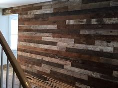 a wooden wall in an empty room with stairs