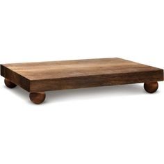 a wooden table sitting on top of a white floor