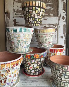 several ceramic pots are sitting on a table