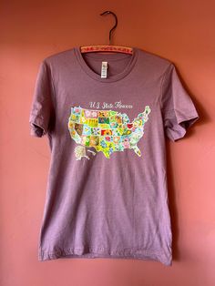 This State Flower Tee is so comfy and cute!  Details: * 100% combed and ring-spun cotton (Heather colors contain polyester) * Fabric weight: 4.2 oz./yd.² (142 g/m²) * Pre-shrunk fabric * Side-seamed construction * Shoulder-to-shoulder taping * Blank product sourced from Nicaragua, Mexico, Honduras, or the US This product is made especially for you as soon as you place an order, which is why it takes us a bit longer to deliver it to you. Making products on demand instead of in bulk helps reduce overproduction, so thank you for making thoughtful purchasing decisions! Heather Cotton T-shirt With Graphic Print, Heather Cotton Graphic Print T-shirt, Cute Purple Relaxed Fit T-shirt, State Flowers, Especially For You, Honduras, Nicaragua, Unisex T Shirt, On Demand