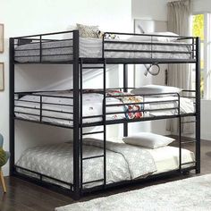 a bunk bed with two sets of mattresses on the bottom and one set below