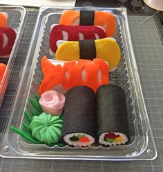 several sushi rolls are arranged in plastic trays