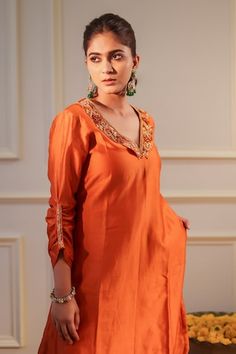 Burnt orange A-line kurta featuring floral hand embroidery around the neckline with gathered sleeve and side pocket. Paired with a straight pant. - Aza Fashions Orange Floral Embroidered Sets, Festive Orange Kurta With Floral Embroidery, Floral Hand Embroidery, Pant Women, Women Kurta, A Line Kurta, Straight Kurta, Gathered Sleeves, Kurta With Pants