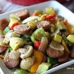 a white plate topped with sausage and veggies