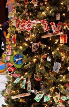 a decorated christmas tree with lots of tags on it