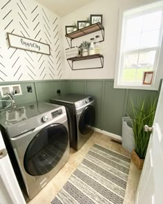 a washer and dryer in a small room with green paint on the walls