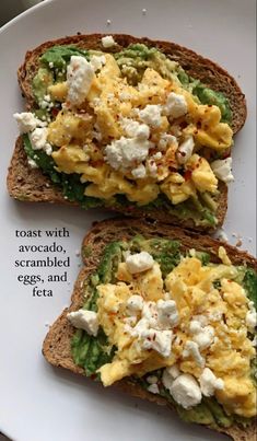 two pieces of bread with eggs and cheese on them are sitting on a white plate