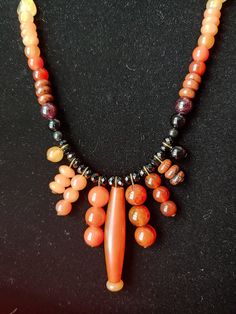 -A 23-inch necklace on Nickel-free Brass-tone chain -An Orange Horn Hairpipe focal bead -Featuring Carnelian, Citrine, Garnet, Mahogany Obsidian, Onyx, Orange Aveturine, Sardonyx Agate, Yellow Jade, and Faceted Glass beads -One Of A Kind Handmade Black Carnelian Necklace, Orange Aventurine, Mahogany Obsidian, Yellow Jade, Stone Beaded Necklace, Chandelier Style, Faceted Glass, Focal Bead, Metal Chain