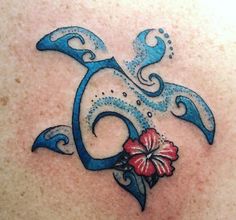 a tattoo design on the back of a woman's upper body, with flowers and swirls