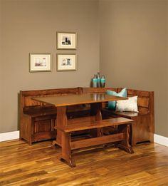 a wooden table with two benches in front of it on top of a hard wood floor