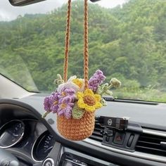 a flower basket hanging from the dashboard of a car