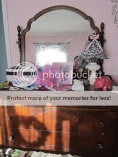 a dresser with a mirror and other items on it