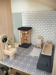 a dollhouse bathroom with black and white flooring