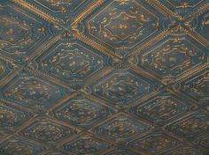 the ceiling is covered in gold and blue paint, with intricate designs on it's surface