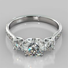 a three stone engagement ring with diamonds on the side