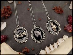 Beautiful vintage witch amulets. I cast the different symbols in clear resin and transformed them into beautiful and unique pieces of jewelry ;) Each amulet is absolutely unique, so variations are possible. The chains are easily adjustable at the back. Would you like to give away the jewelry in a very special way? Then order one of these beautiful black boxes ;)) https://www.etsy.com/de/listing/1333591783/black-box-kleine-schwarze-schmuck?click_key=bb1c70442a805c72f1af6c7485be3f2c75ec9b9a%3A1333591783&click_sum=39f4b11d&ref=shop_home_active_1 Otherwise, I would also be happy to pack your order as a gift! Please select the gift packaging during the ordering process ;)) Pendant: 4 x 3 cm Chain length: 45-50 cm Material: metal / resin Color: Silver/Black Gothic Moon Charm Pendant Necklaces, Gothic Moon Charm Pendant Necklace, Gothic Pendant Necklaces With Moon Charm, Gothic Necklaces With Moon Charm Pendant, Witch Amulet, Triple Moon Pentagram, Moon Pentagram, Different Symbols, Witch Necklace