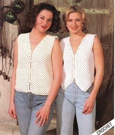 two women standing next to each other wearing white tops