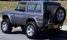 a gray jeep parked on the side of a road