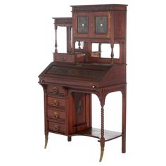 an antique wooden desk with two drawers and a clock on it's top shelf