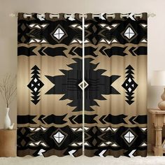 a window curtain with an abstract design on it in black and gold colors, sitting next to a table