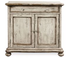 an old white wooden cabinet with two doors and one drawer on the bottom, against a white background