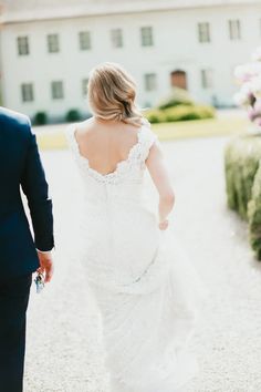 the bride and groom are walking down the path to their wedding reception at this elegant venue