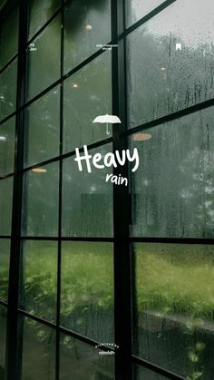 a window with the words heavy rain written on it