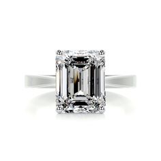 an emerald - cut diamond ring with two caramel bands on the band, set in 18k rose gold