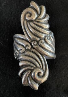 Vintage mid-century sterling silver clamper cuff. This piece has a beautiful detailed leaf/swirl motif and a classic in Taxco Mexico design genre. Easily and comfortably fits most wrists with its hinged closure at the back allowing size flexibility.   Vintage Taxco Mexico Sterling Silver 1940's-1950's Clamper Cuff; Hallmark stamp is CP; eagle stamp is illegible. Photography was difficult due to position of stamps. Dimensions- Size: 7.75" outer circumference  Height: 4" inches; 1.5" near back hinge Width: 3" across front Weight: 60g/2.1oz. Mexican Silver Jewelry Vintage, Mexican Silver Jewelry, Mexico Design, Jewelry Vintage, Sterling Silber, Cuff Bracelets, Swirl, Vintage Jewelry, Jewelry Collection