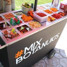 a food stand with many different types of foods on it's sides and the words bonan kiosk written in large letters