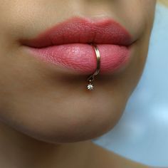 a close up of a person with a ring on their lip