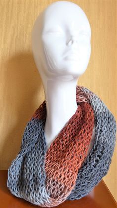 Handmade open weave infinity scarf made with 80% Acrylic, 20% wool yarn. Designed to wear doubled around the neck this scarf is beautifully soft and drapes well.  The open weave traps the warm air keeping you cosy and comfortable. Knitted a graduated yarn the woodland colours within the scarf range from light grey through to charcoal, rust and brown. Machine washable at 30 degrees.  Do not iron or tumble dry. Note: It is a good idea to wash the scarf in a pillow case so that the open weave doesn One Size Yarn Infinity Scarf, Yarn Infinity Loop Scarf For Fall, Yarn Infinity Scarf For Fall, Fall Yarn Infinity Scarf In Loop Shape, Hand Knitted Yarn Infinity Scarf, Fall Knit Infinity Scarf, Hand Knitted Loop Scarf For Fall, Hand Knitted Loop Scarves For Fall, Hand-knitted Loop Scarf For Fall