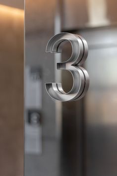 the number three is etched into glass to give it a modern feel and shines