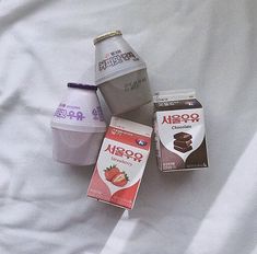 four different types of milkshakes on a bed