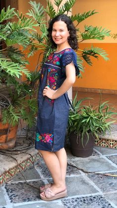 Beautiful denim dress embroidered by hand by artisans from the state of Oaxaca, Mx. comfortable and fresh, with lace details and drawstring to adjust at the waist. The embroidery is unique to each dress so it may vary. Mexican textile art has centuries of history and creativity throughout the country. Mexico is recognized as one of the leading countries with a beautiful artistic production in the textile world, miraculous hands of talented artisans from different states of the country create stu Modern Mexican Dress Embroidery, Floral Embroidered Fitted Denim Dress, Sunflower Mexican Dress, Traditional Sleeveless Embroidered Fiesta Dress, Modern Embroiled Mexican Dress, Blanket Dress, Cool Denim, Mexican Textiles, Mexican Blouse