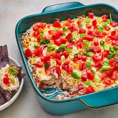 a casserole dish with tortilla chips and salsa