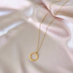 Our signature gold circle necklace is designed for layering over any necklace in our collection. Handmade, tarnish resistant 14k gold plated chain. Adjustable between 16"-18". Dainty Gold Chain Round Charm Necklace, Dainty Gold Chain Round Necklaces, Dainty Round Gold Chain Necklace, Gold Circular Jewelry With Cable Chain, Everyday Circular Yellow Gold Necklace, Everyday Yellow Gold Circular Necklace, Gold Necklaces With Delicate Open Circle Chain, Everyday Gold Chain Charm Necklace With Pendant, Gold Full Circle Necklaces With Adjustable Chain