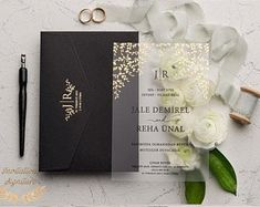 wedding stationery with white flowers and gold foil on the front, black paper in the back